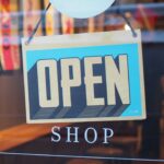 Open shop sign in a store as SAP and Google Cloud are deploying agentic commerce architecture to automate multi-agent marketing and retail operations at enterprise scale.